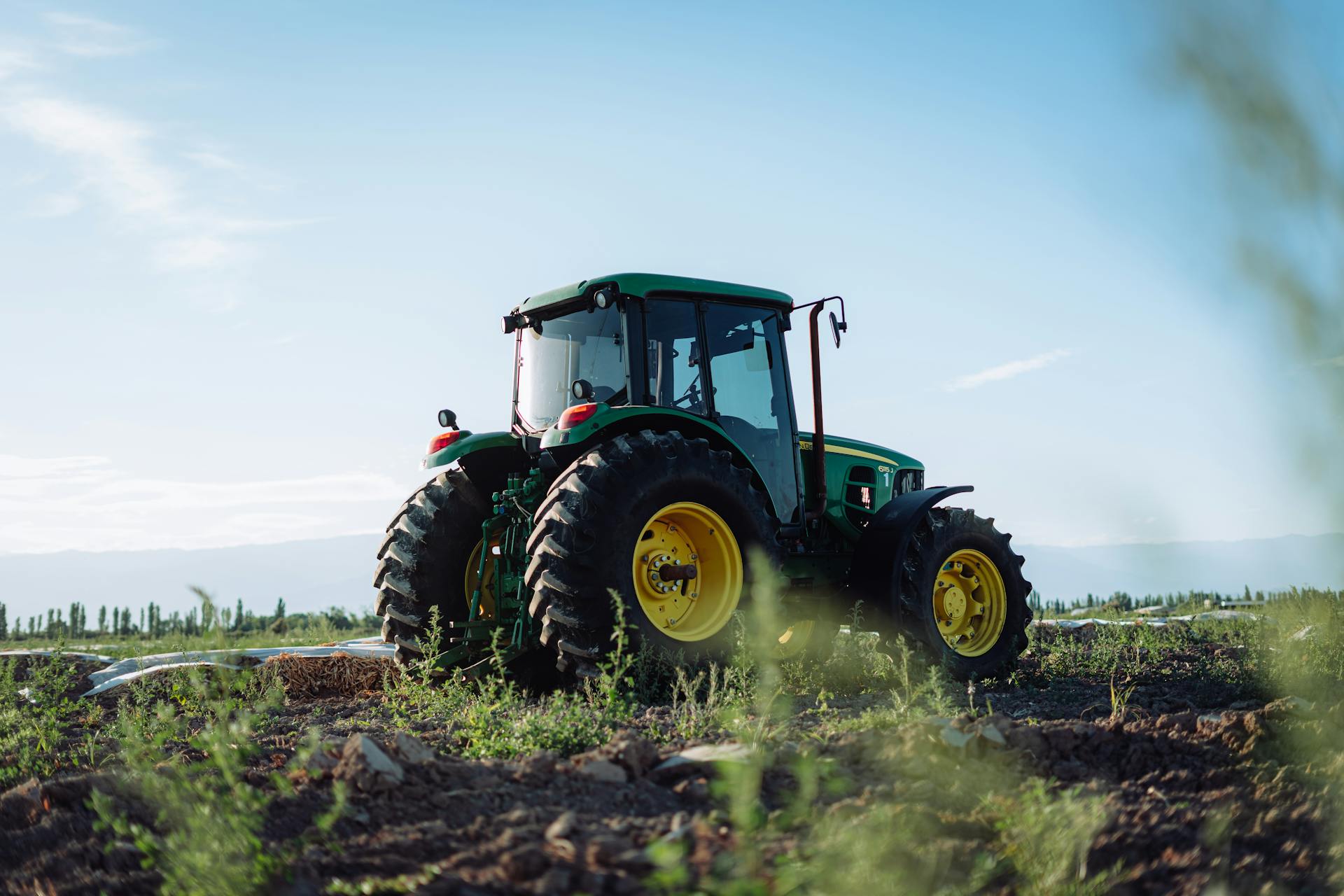 Modern tractor with agricultural implements in Indian farmland - Bharat Krushi Yantra premium farming equipment